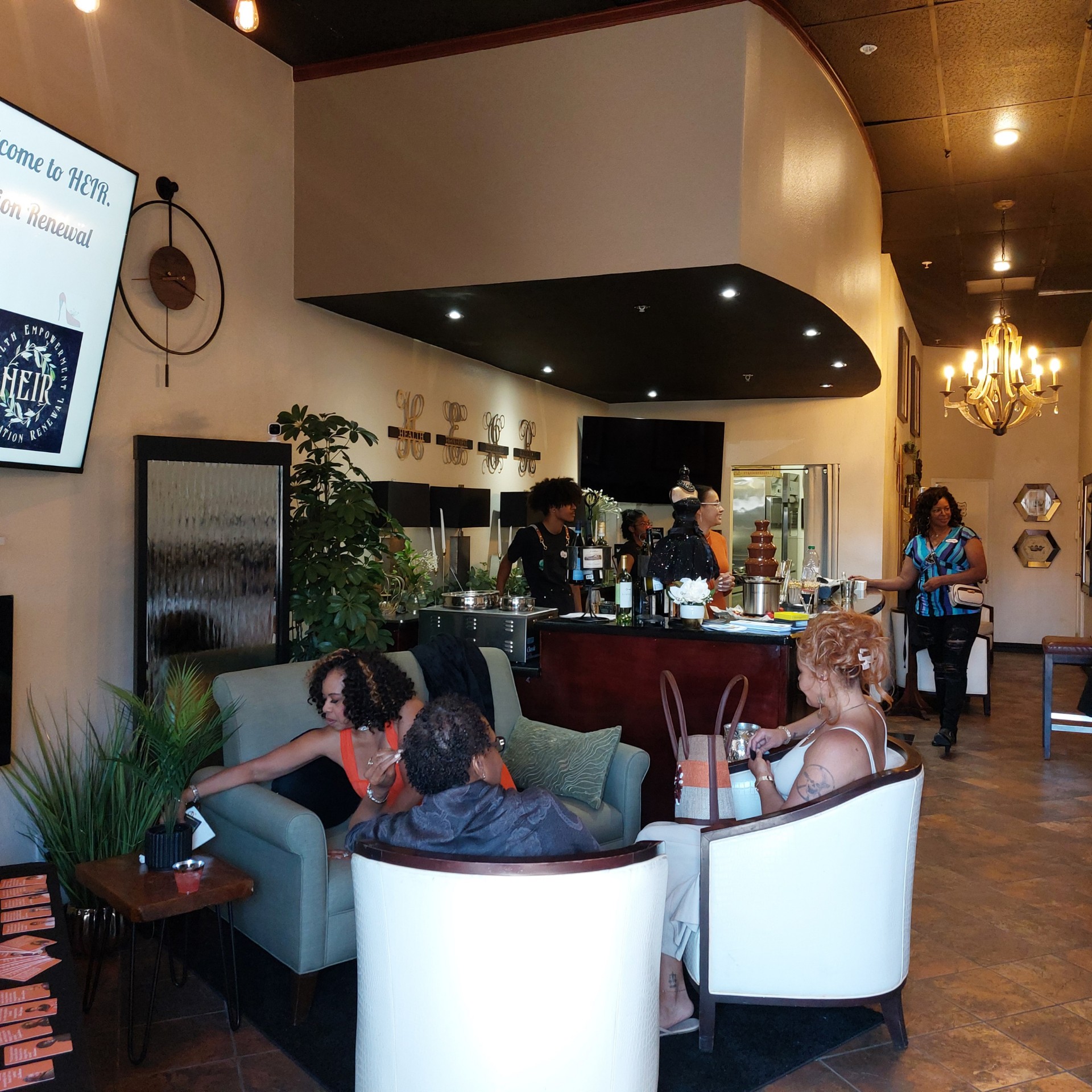 Guests relaxing and laughing together in a warm café lounge